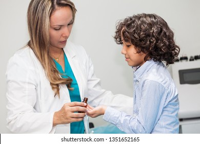 Doctor Giving A Child Homeopathic Medicine Or Vaccine