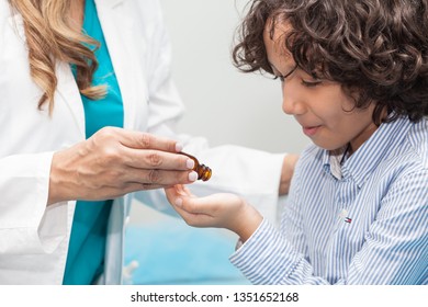 Doctor Giving A Child Homeopathic Medicine Or Vaccine