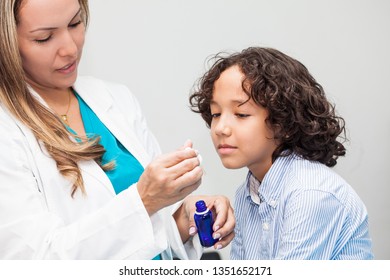 Doctor Giving A Child Homeopathic Medicine Or Vaccine