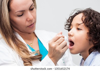 Doctor Giving A Child Homeopathic Medicine Or Vaccine