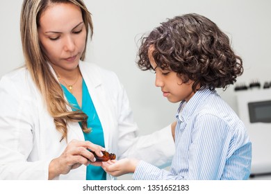 Doctor Giving A Child Homeopathic Medicine Or Vaccine