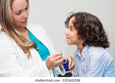 Doctor Giving A Child Homeopathic Medicine Or Vaccine