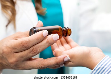 Doctor Giving A Child Homeopathic Medicine Or Vaccine