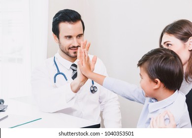 Doctor Giving Hi Five With Patient Boy In Hospital.healthcare And Medicine