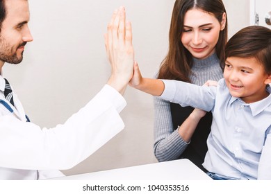 Doctor Giving Hi Five With Patient Boy In Hospital.healthcare And Medicine