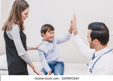 Doctor Giving Hi Five With Patient Boy In Hospital.healthcare And Medicine