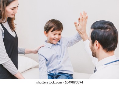 Doctor Giving Hi Five With Patient Boy In Hospital.healthcare And Medicine