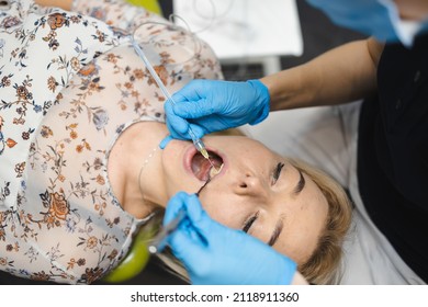 Doctor Giving Painkiller Injection To Woman Patient Using  Dental Computer Anesthesia Machine