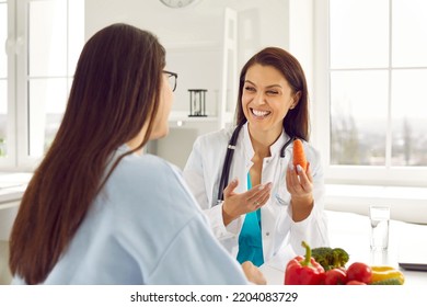 Doctor Giving Patient Consultation On Good Nutrition Habits. Happy Dietitian Or Nutritionist Helping Woman With Diet Plan And Weight Loss, Sharing Wellness Advice, Explaining Which Foods Are Healthy