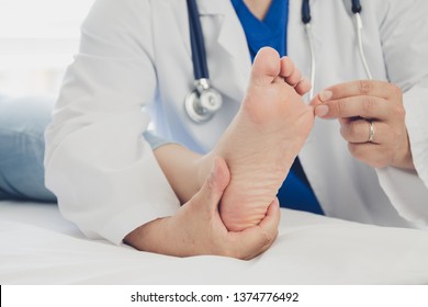 Doctor Giving A Patient Foot Treatment