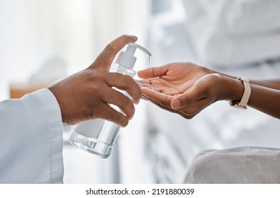 Doctor Giving Patient Hand Sanitizer For Protection, Hygiene And Bacteria Disinfection In Covid Pandemic, Protocol And Virus. Healthcare Safety And Cleaning Hands To Prevent Flu, Corona And Illness