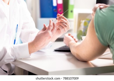 Doctor Giving Patient Vaccine, Flu Or Influenza Shot Or Taking Blood Test With Needle. Medicine, Insulin Or Vaccination. Nurse With Injection Or Syringe. Hospital Office Room.