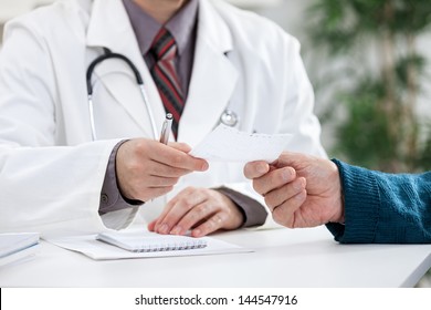 Doctor Giving A Prescription To His Patient