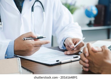 Doctor giving a prescription to the patient. Doctor hand holds silver pen filling patient history list at clipboard pad. Physical, exam, disease prevention, ward round, - Shutterstock ID 2016164891