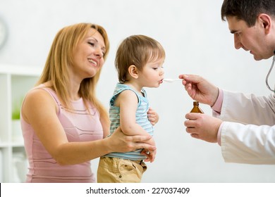 Doctor Giving Spoon Dose Of Medicine Liquid Drinking Syrup To Child Boy Patient