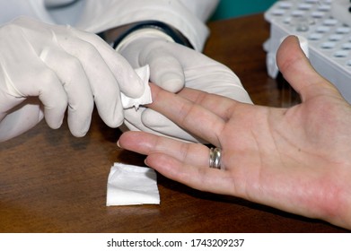 A Doctor With Gloves Does A Blood Test On A Patient