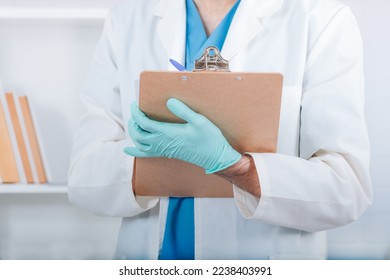 doctor with gloves and folder taking notes or reporting