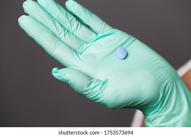 Doctor In Gloves Holds Pills For Men's Sexual Health