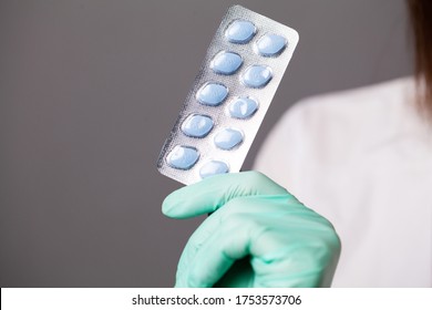 Doctor In Gloves Holds Pills For Men's Sexual Health