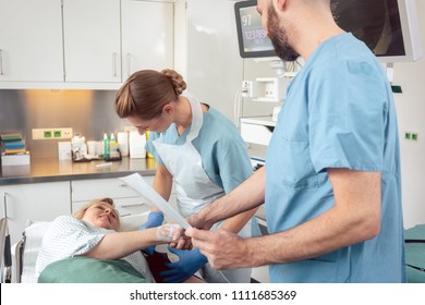 Doctor greeting patient before starting treatment in hospital