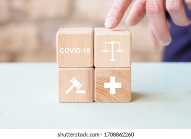 Doctor Hand Arranging Wood Block Stacking With Icon Justice Healthcare. Labor Law Lawyer Legal Concept In Medical On The Theme Of Coronavirus.