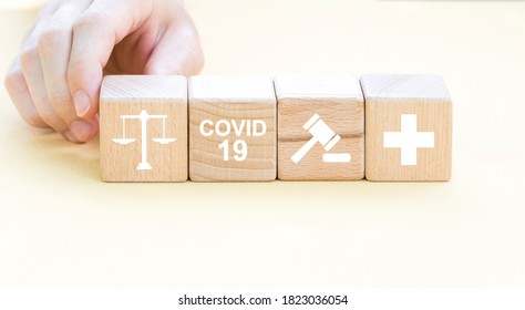 Doctor Hand Arranging Wood Block Stacking With Icon Justice Health Care. Labor Law Lawyer Legal Concept In Medical On The Theme Of Coronavirus.