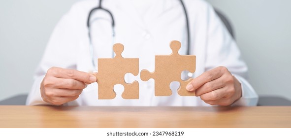 Doctor hand connecting couple puzzle piece, wooden jigsaw in hospital. Teamwork, Idea, Solution, challenge, success, Health, Medical and strategy concepts - Powered by Shutterstock - Get 15% off with code: PIKWIZARD15
