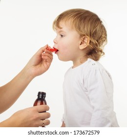 Doctor Hand Giving Spoon Dose Of Medicine Liquid Drinking Syrup To Child  