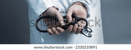 doctor hand handcuffs with stethoscope
