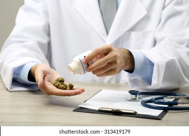 Doctor Hand Holding Bottle With Medical Cannabis Close Up