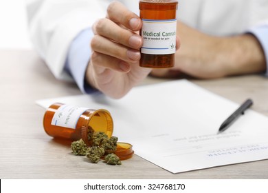 Doctor Hand Holding Bottle With Medical Cannabis Close Up