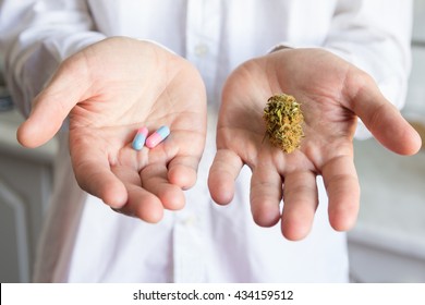 Doctor Hand Holding Bud Of Medical Cannabis And Pills