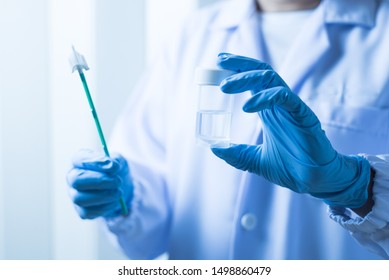 Doctor Hand Holding Liquid Base Cytology Set On Blue Background.Gynecologist Working For Vaginal And Cervix Pap Smear Patient In The Obstetrics And Gynecology Department.Medical Concept.