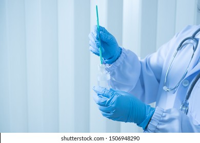 Doctor Hand Holding Liquid Base Cytology Set On Blue Background.Gynecologist Working For Vaginal And Cervix Pap Smear Patient In The Obstetrics And Gynecology Department.Medical Concept.