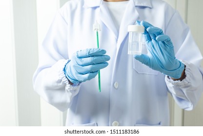 Doctor hand holding liquid base cytology set on blue background.Gynecologist working for vaginal and cervix pap smear patient in the obstetrics and gynecology department.Medical concept.
