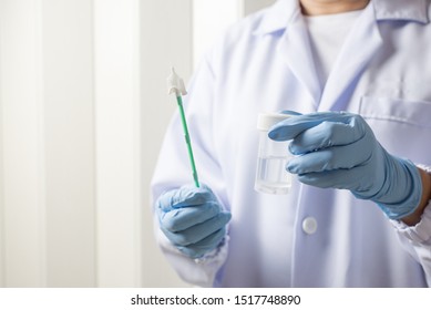 Doctor Hand Holding Liquid Base Cytology Set On Blue Background.Gynecologist Working For Vaginal And Cervix Pap Smear Patient In The Obstetrics And Gynecology Department.Medical Concept.