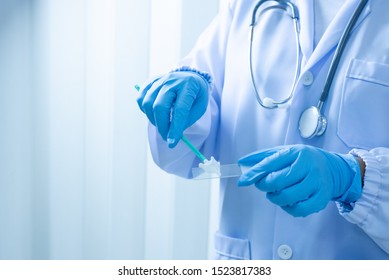 Doctor Hand Holding Liquid Base Cytology Set On Blue Background.Gynecologist Working For Vaginal And Cervix Pap Smear Patient In The Obstetrics And Gynecology Department.Medical Concept.