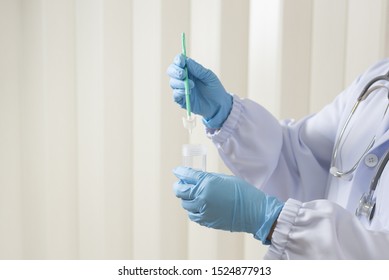 Doctor Hand Holding Liquid Base Cytology Set On Blue Background.Gynecologist Working For Vaginal And Cervix Pap Smear Patient In The Obstetrics And Gynecology Department.Medical Concept.