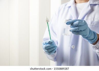 Doctor Hand Holding Liquid Base Cytology Set On Blue Background.Gynecologist Working For Vaginal And Cervix Pap Smear Patient In The Obstetrics And Gynecology Department.Medical Concept.