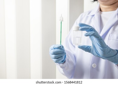 Doctor hand holding liquid base cytology set on blue background.Gynecologist working for vaginal and cervix pap smear patient in the obstetrics and gynecology department.Medical concept.