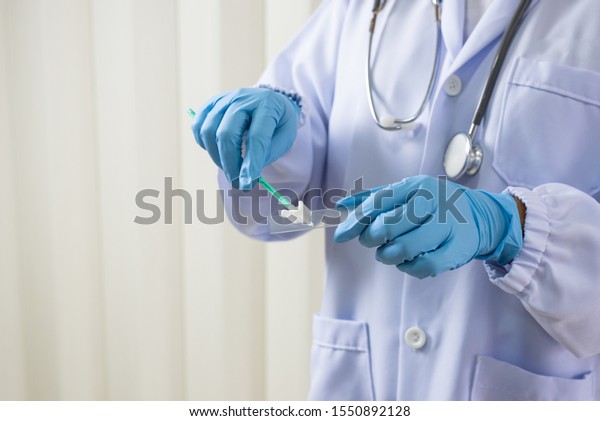 Doctor hand\
holding spatula and glass slide cytology set.Gynecologist working\
for vaginal and cervix pap smear patient in the obstetrics and\
gynecology department.Medical\
concept.