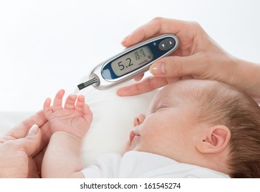 Doctor Hand Measuring Glucose Level Blood Test From Diabetes Patient Child Baby Using Glucometer And Small Drop Of Blood From Finger And Test Strips Isolated On A White Background