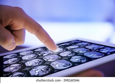 Doctor hand touching modern digital tablet, close up