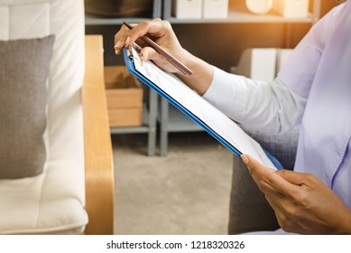 The Doctor Hand Is Writing Patient Information,the Record For Treatment Program,warm Light Tone,blurry Light Around