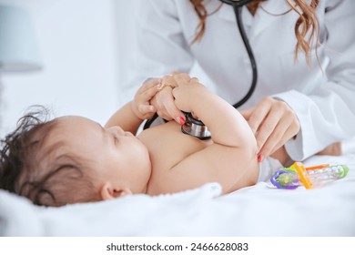 Doctor, hands and baby with stethoscope for heartbeat, exam or test in healthcare on bed at home. Woman or pediatrician checking infant, toddler or young newborn for medical care in bedroom at house - Powered by Shutterstock