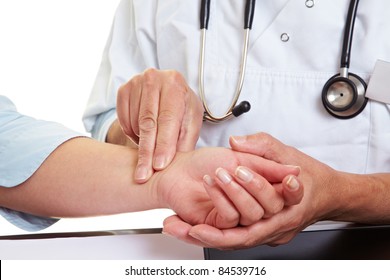 Doctor Hands Feeling Pulse On Female Wrist