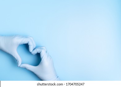 Doctor Hands With Gloves Making Heart Shape On Blue Background