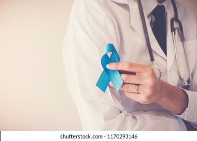 Doctor Hands Holding Light Blue Ribbon,  Prostate Cancer Awareness, November Blue, Movember Men Health Concept