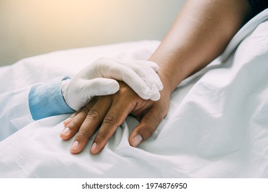 Doctor Hands Holding Patient Hand For Encouragement And Empathy With Morning Light. Partnership, Trust And Medical Ethics Concept. 