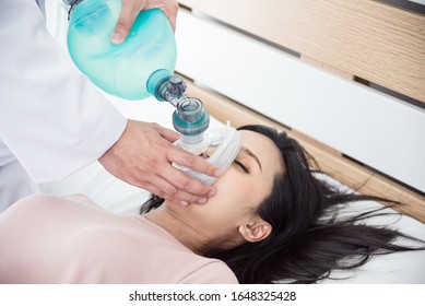 Doctor Hands Holding Resuscitation Bag .Medical Team Helping A Woman Who Are Not Breathing With Ambu Bag In CPR  , Cardiopulmonary Resuscitation Process.